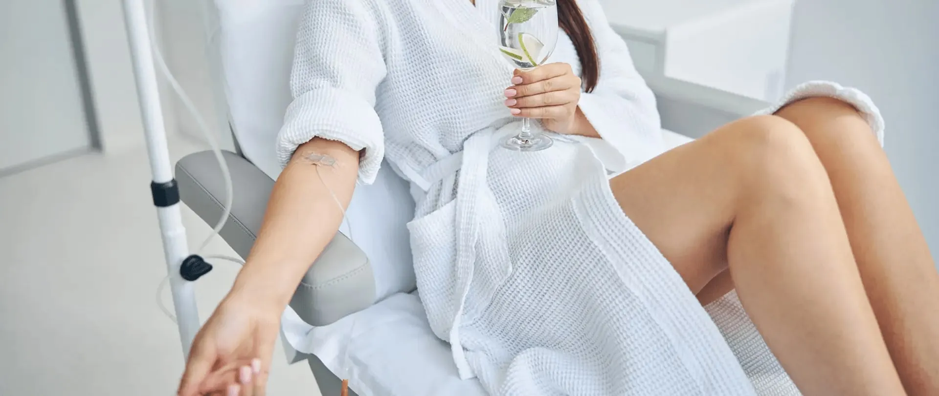 A client relaxing in a robe during an NAD+ infusion