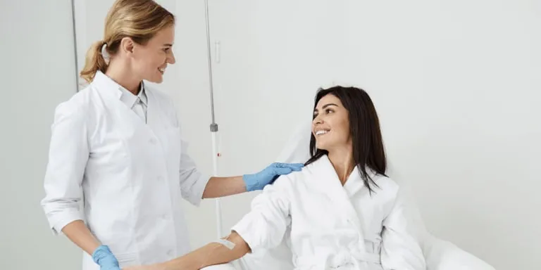 A nurse checking in with a client during an infusion